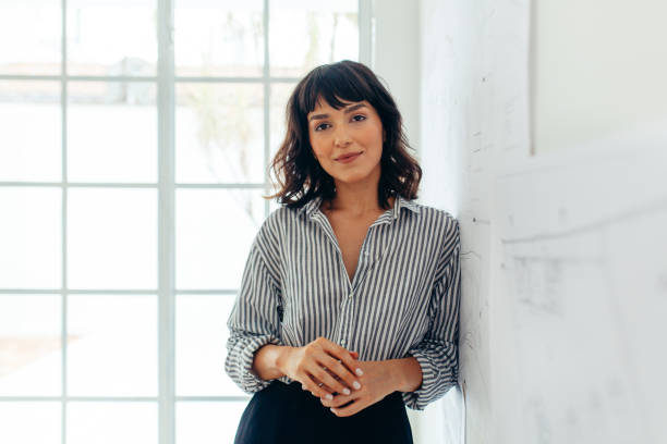 Businesswoman standing in office. Portrait of a confident businesswoman